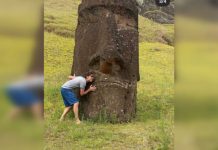 Turista arriesga sanciones tras abrazar y tomarse fotografías con moai en Rapa Nui